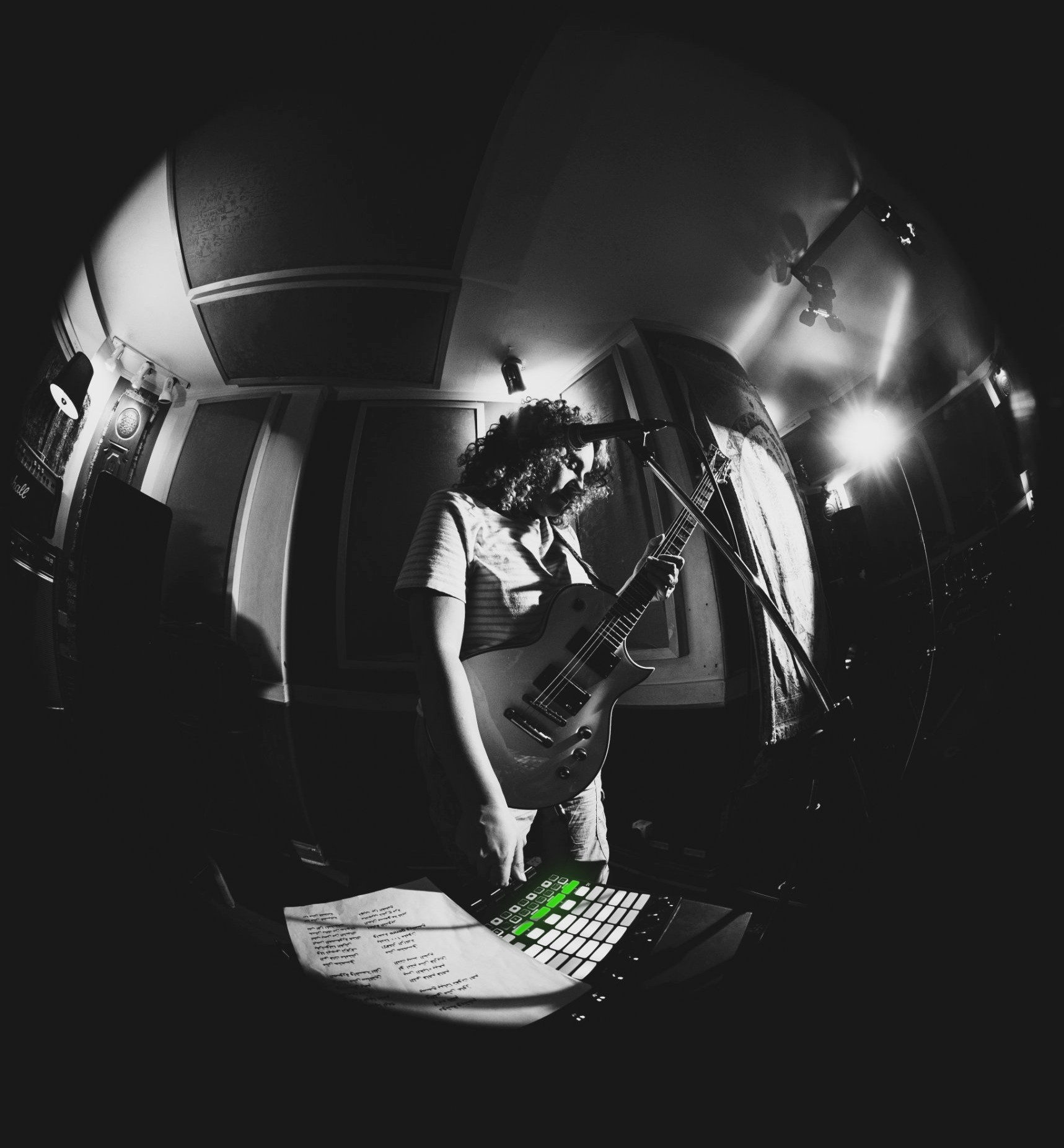 CHEEN playing guitar in the studio